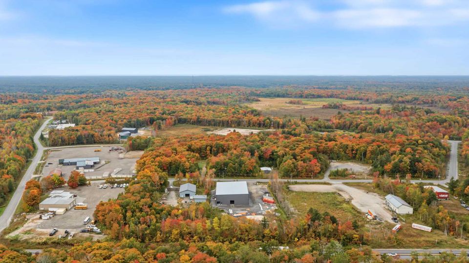 Wide aerial of the industrial park and surrounding forest