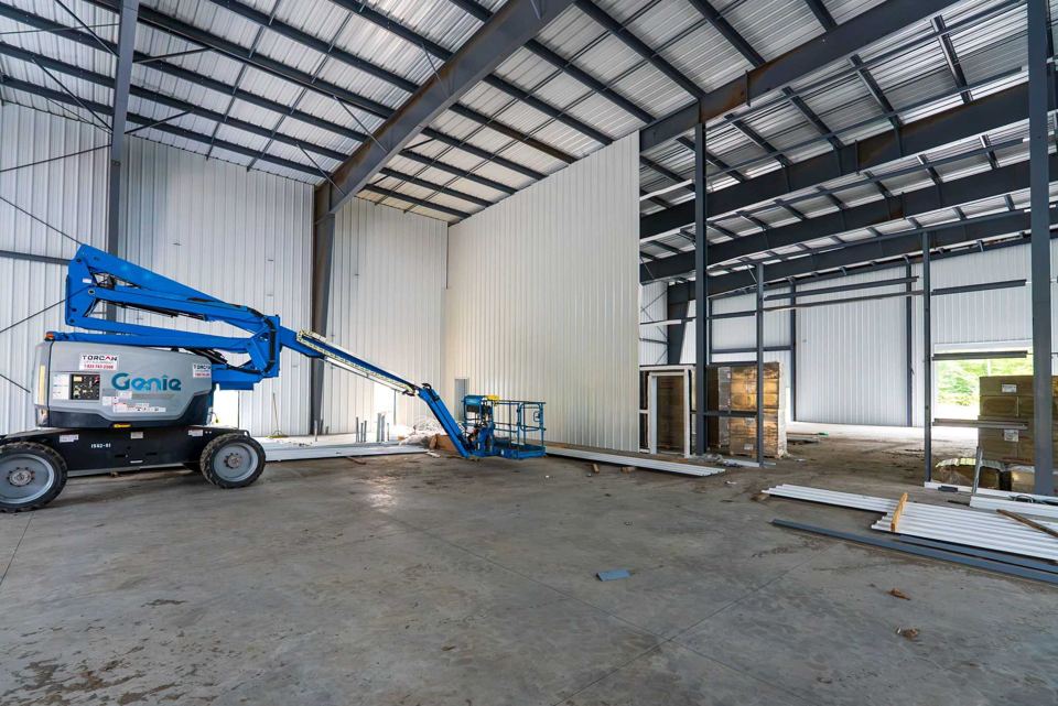 Boom lift inside a tall open bay
